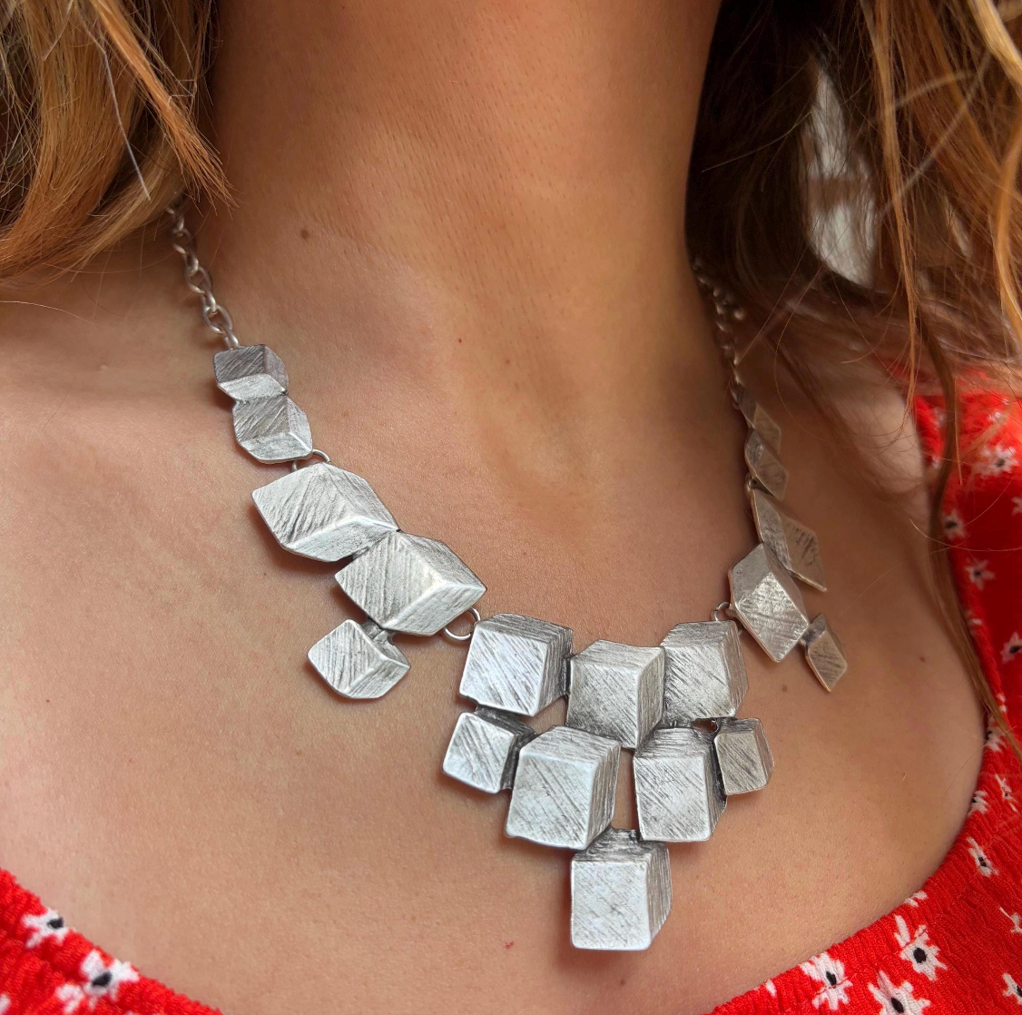 Artisan Texture: Each cube in this cluster necklace features a unique brushed texture, catching the light beautifully for a subtle yet impactful shimmer.