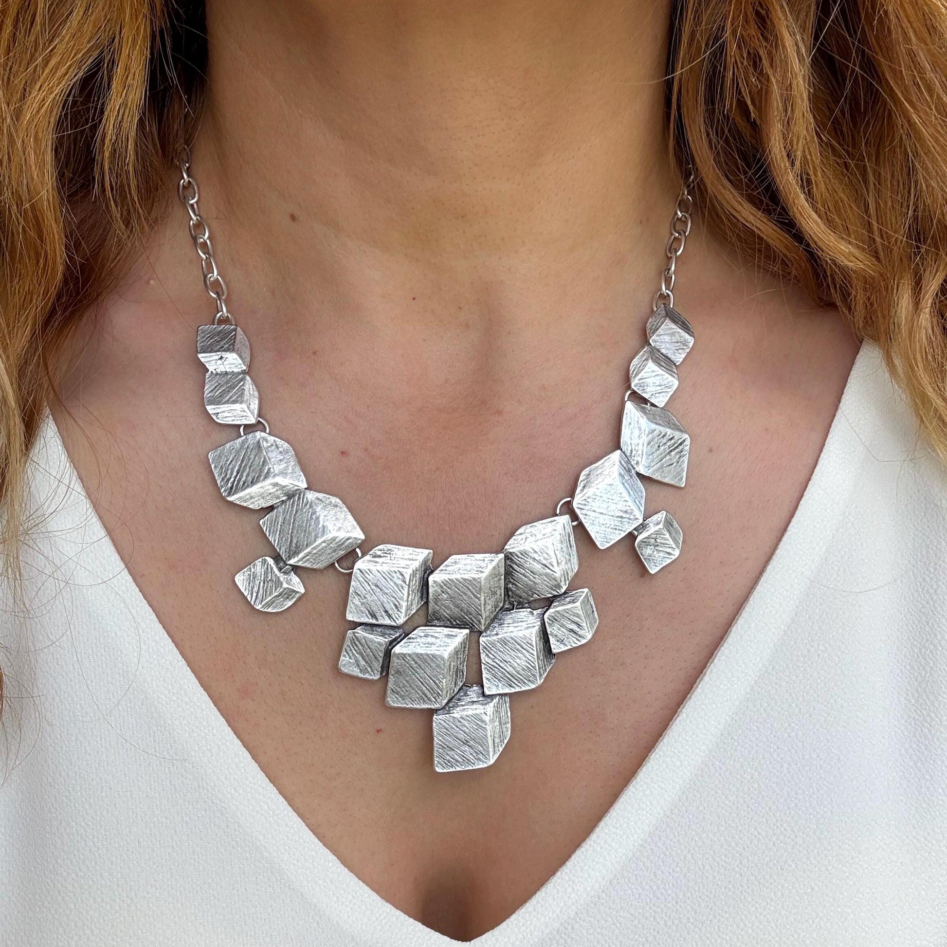 Bold & Beautiful: Designed for the woman who isn't afraid to stand out. The multi-dimensional cube design creates a striking silhouette on the neckline.