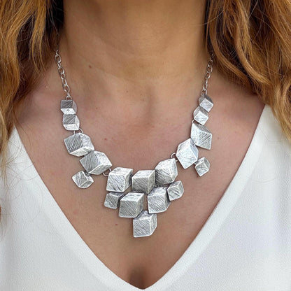 Bold & Beautiful: Designed for the woman who isn't afraid to stand out. The multi-dimensional cube design creates a striking silhouette on the neckline.