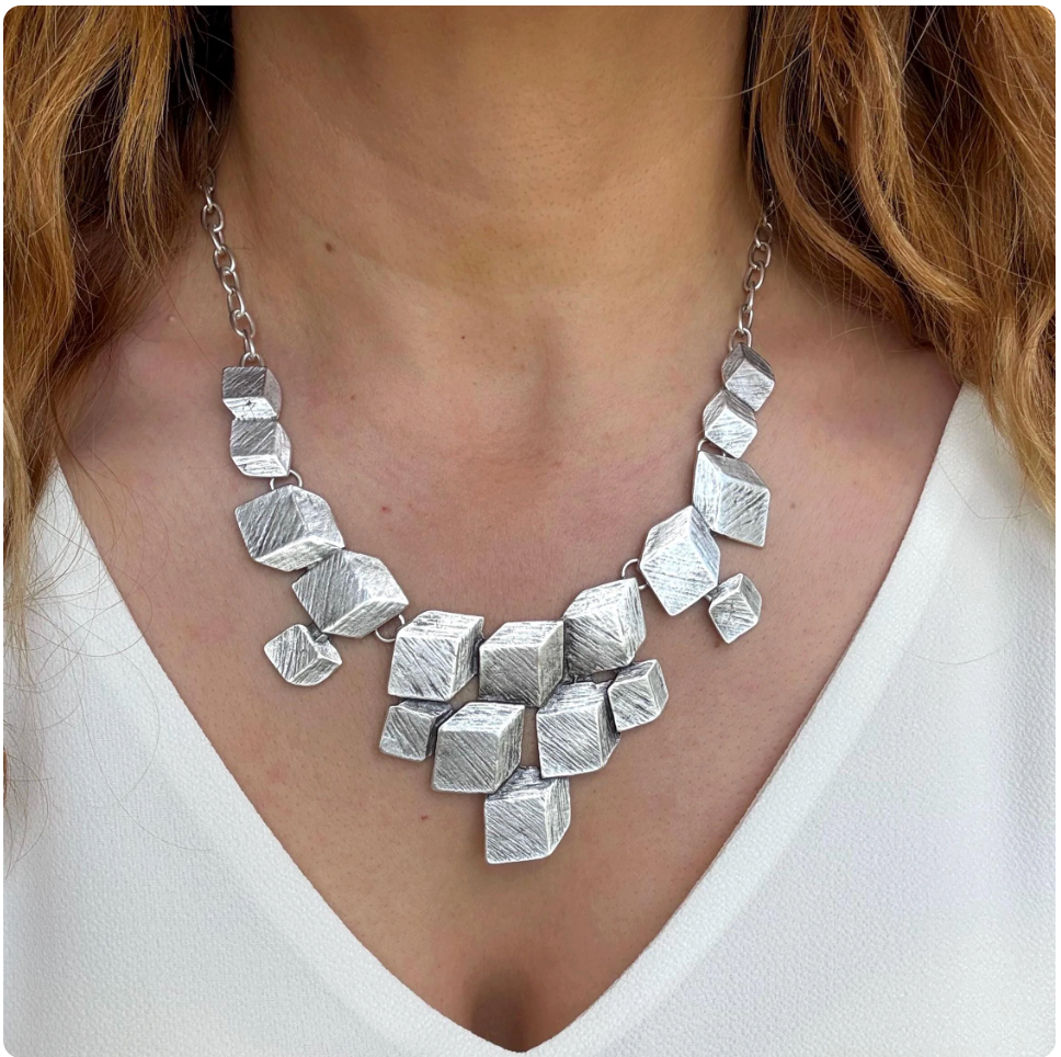 Architectural Elegance: Inspired by modern architecture, this necklace features a series of 3D cubes with a brushed matte finish. A true wearable piece of art.