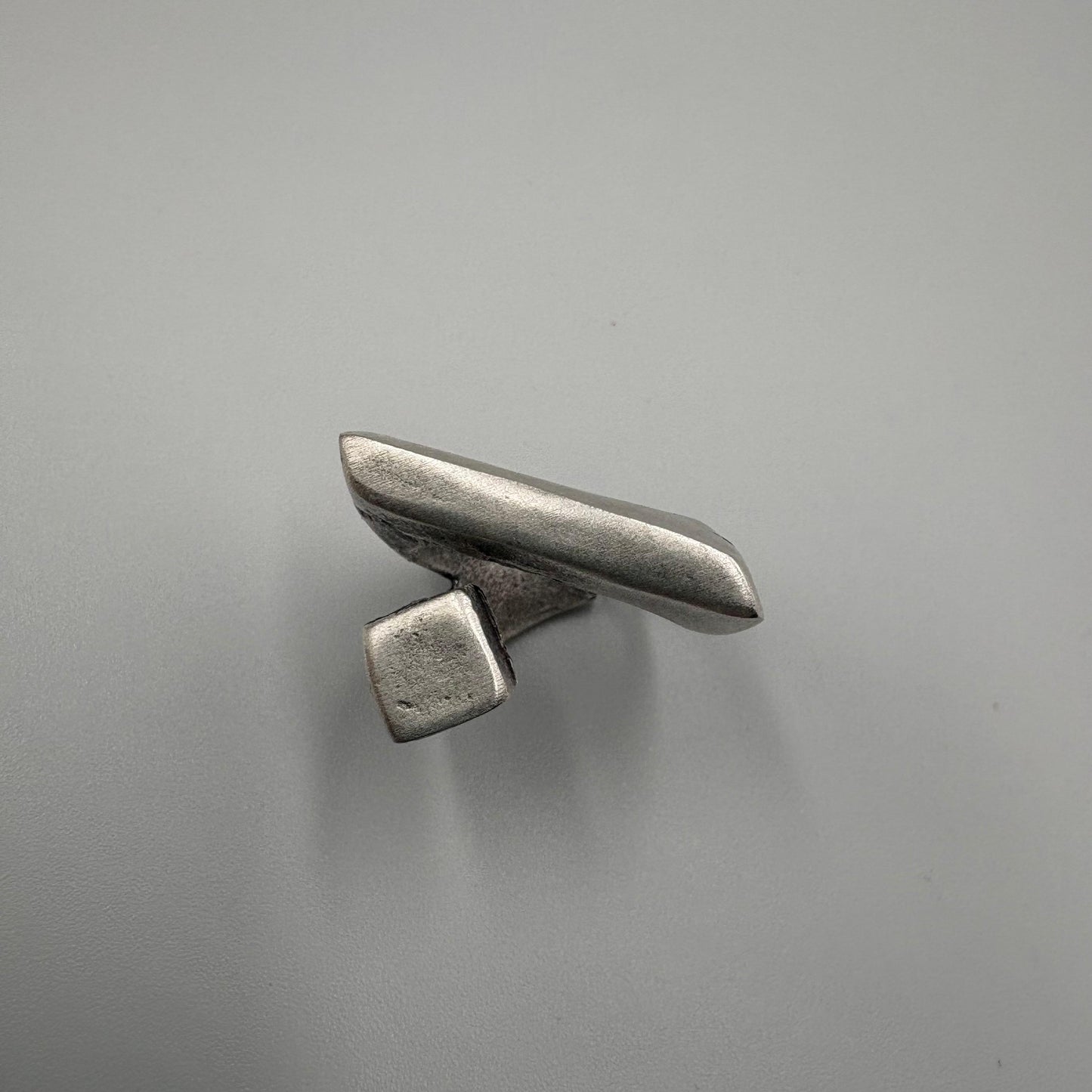 Metallic object on a gray background