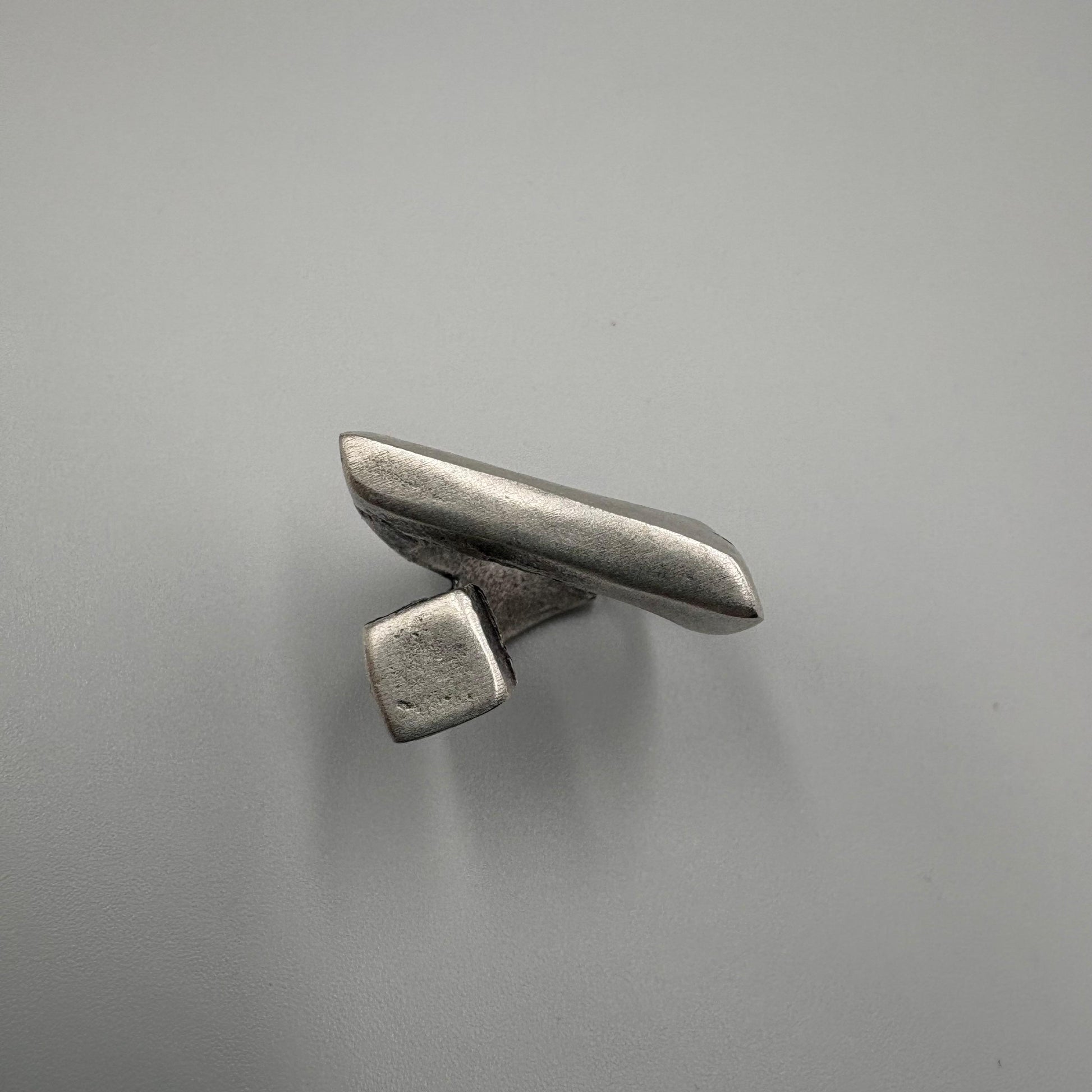 Metallic object on a gray background