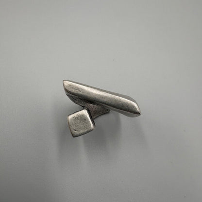 Metallic object on a gray background